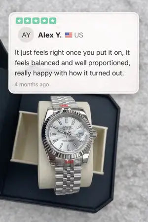 Silver stainless steel rolex datejust watch with a white dial and fluted bezel.